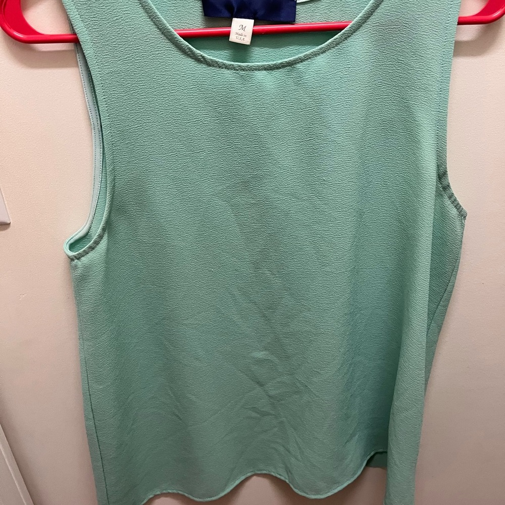 sleeveless teal blouse